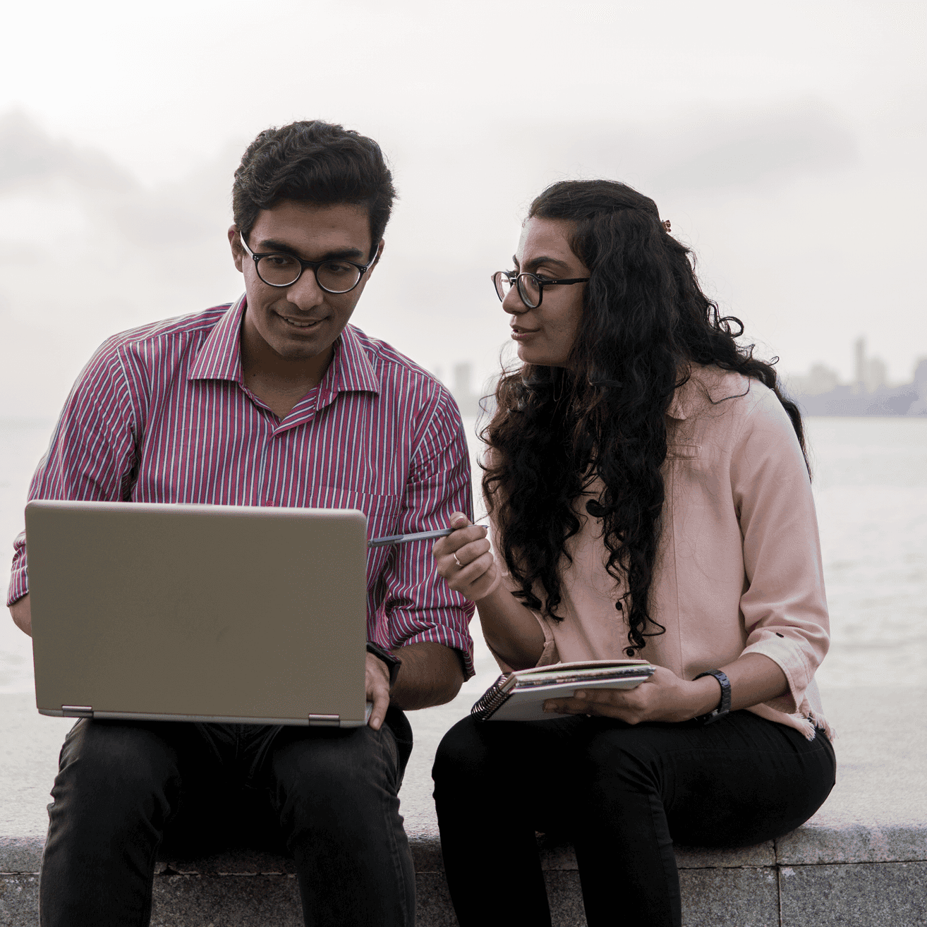 two people looking at laptop